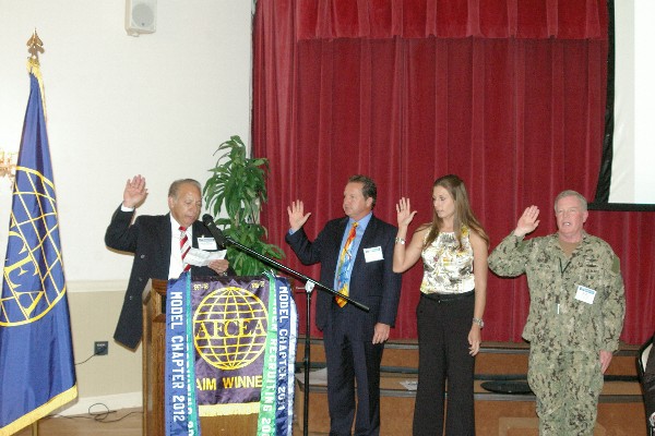 In February, Ramos (l) inducts new members of the chapter's board.